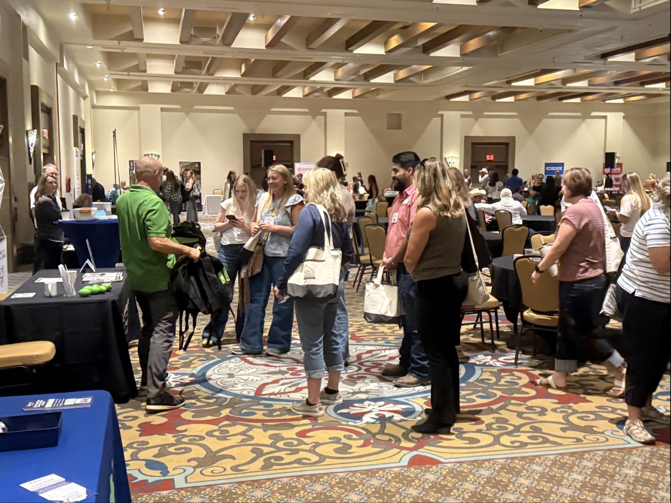 Compushooter team speaking with business owners at an event